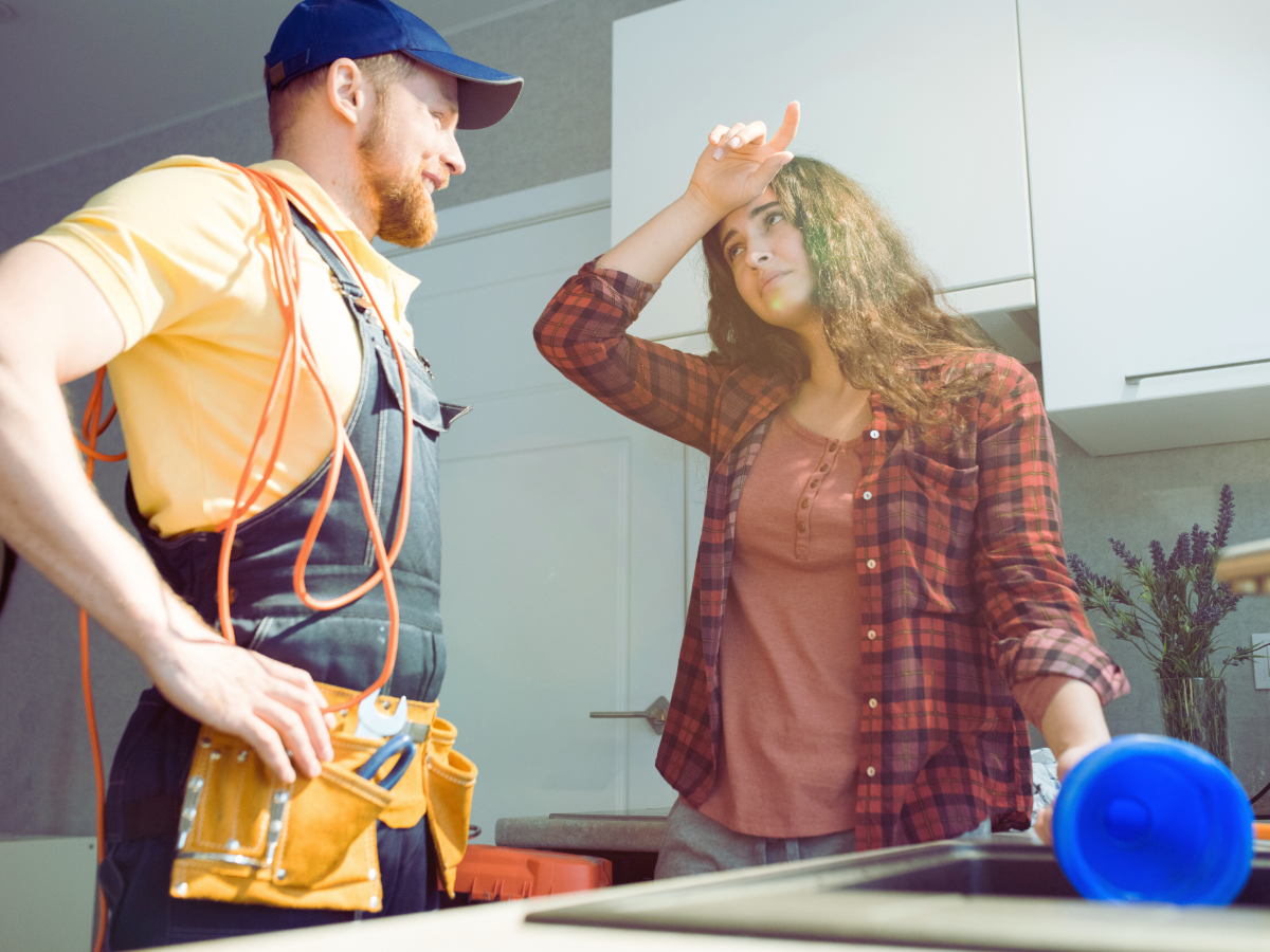 plumber helping homeowner with clogged sink