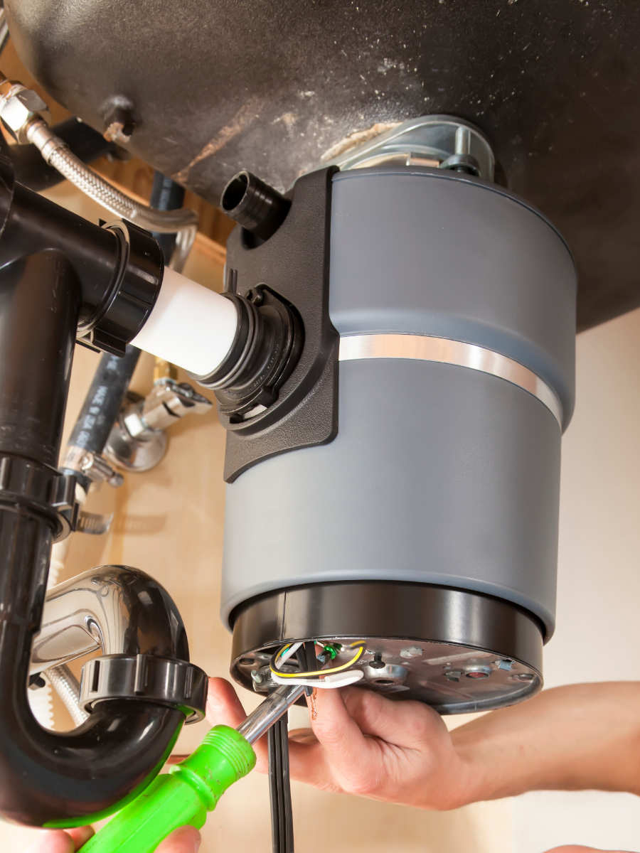 Plumber repairing garbage disposal