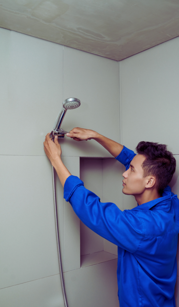 homeowner performing DIY fix for leaking showerhead